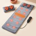 Full-body massage mat with detachable neck pillow on a cream background
